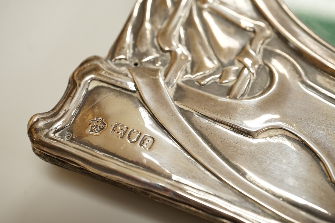 An Edwardian Art Nouveau silver mounted shaped rectangular photograph frame, by William Hutton & Sons, London 1901, decorated with a maiden amongst foliage, 19.5cm.